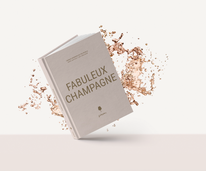 Couverture du livre « Fabuleux Champagne ». La couverture est unie, de couleur rose pâle, avec un titre doré. Derrière la couverture, on aperçoit des gouttes de champagne.